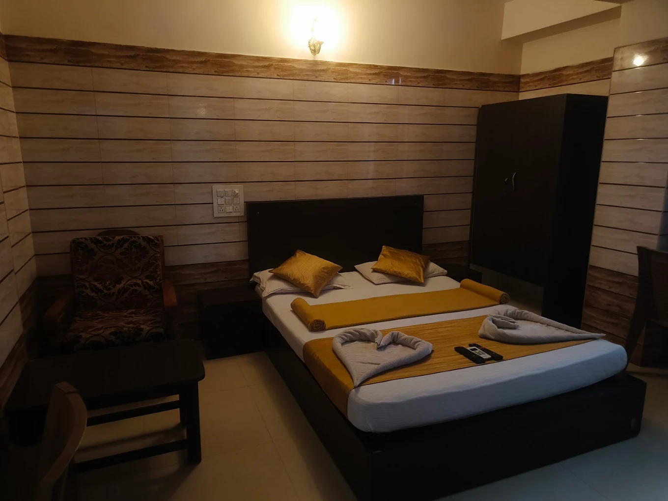 Standard room bed and interior at Yamuna Vihar Tourist Home